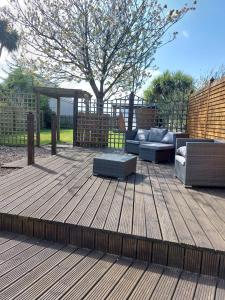 a wooden deck with couches and a gazebo at Saltwater Cottage in Dunseverick