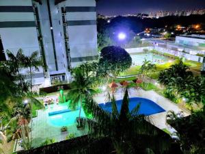 an overhead view of a large swimming pool at night at Apartamento Compartilhado, com 02 Quartos, sendo 01 suíte in Manaus