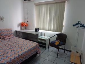 a bedroom with a bed and a sink and a chair at Apartamento Compartilhado, com 02 Quartos, sendo 01 suíte in Manaus