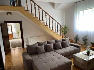 a living room with a couch and a staircase at Oficial Haus in Cristian