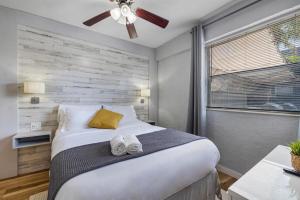 a bedroom with a large bed with a ceiling fan at Seascape - Mins to Las Olas & Beach in Fort Lauderdale