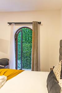 a bedroom with a bed and a window at Casa Castillo in Mexico City