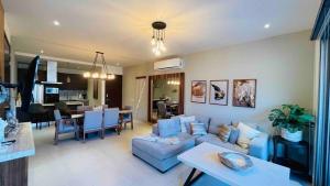 a living room with a blue couch and a table at CONDO VISTA AL MAR ZONA TEZAL in Cabo San Lucas