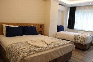 Postel nebo postele na pokoji v ubytování Dab Hotel Ulus