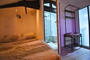 a bedroom with a bunk bed and a bathroom at Spa de la Nacre, L'étape Repos in Andeville