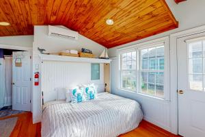 a bedroom with a bed and a wooden ceiling at The Atlantic in Yarmouth