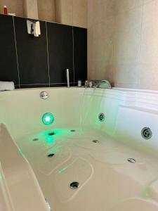 a white bath tub with green lights in it at Seven hotel in Santa Fe de Antioquia