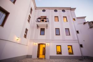 a large white building with a balcony on it at Hotel Hana in Mostar