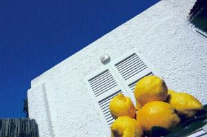 a pile of oranges sitting in front of a window at Aparthotel Villa Marinù in Ischia