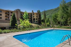 a swimming pool in front of a building at Fall Ridge in Vail