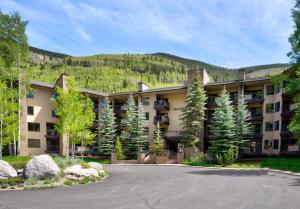 a large apartment building with a mountain in the background at Fall Ridge in Vail