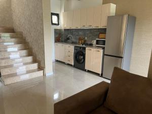 a kitchen with a refrigerator and a stove at Villa for families and friends 2 in Tbilisi City