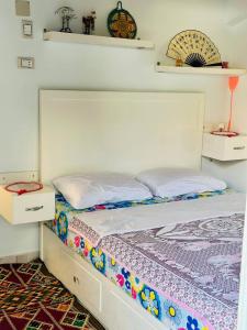 a bed in a room with two drawers and a bed sidx sidx at MasTonKel in Aswan