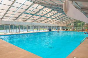 a large swimming pool with a large glass ceiling at River's Creekside Cabin in Ellijay