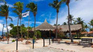 ein Resort am Strand mit Palmen und einer Flagge in der Unterkunft Sunsol Punta Blanca in San Pedro de Coche