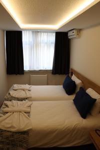 Postel nebo postele na pokoji v ubytování Dab Hotel Ulus