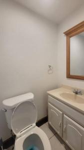 a bathroom with a white toilet and a sink at Entire 4 bedroom house - Enfield in Enfield