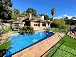 una piscina di fronte a una casa di CASA PARAÍSO PISCINA TRANQUILIDAD a Sant Cebrià de Vallalta