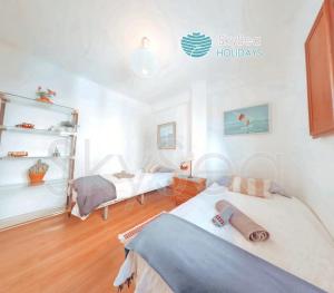 a bedroom with two beds in a room at SkySea Holidays MALAGA BAILEN in Málaga