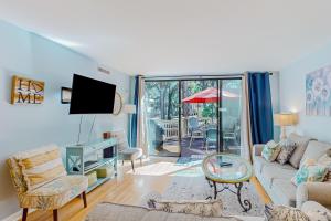 a living room with a couch and a tv at Seascape Villas, Unit 3239 in Hilton Head Island