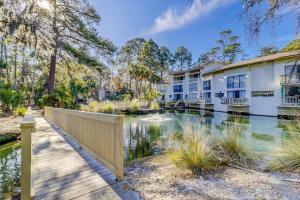 a walkway in front of apartment buildings with a pond at Seascape Villas, Unit 3239 in Hilton Head Island
