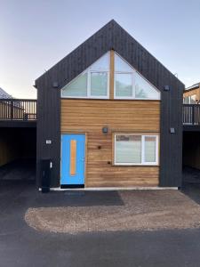 a house with a blue door on the front of it at Hytte på sørlandet in Kristiansand