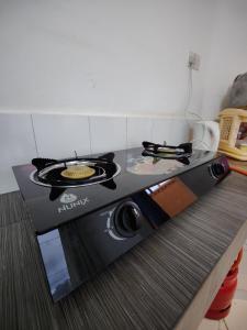 a stove top oven sitting on top of a counter at The Majestic Royal Palms, Mtwapa in Shimo la Tewa