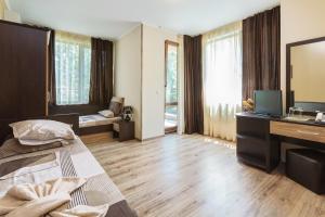 a bedroom with a bed and a desk with a computer at Villa Brigantina in Sunny Beach +74 photos