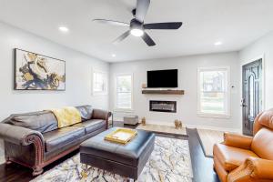 a living room with a couch and a ceiling fan at Isabella Duplex - A in Houston