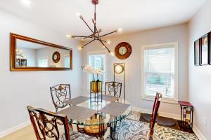 a dining room with a table and chairs and a mirror at Isabella Duplex - A in Houston