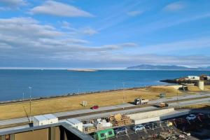 a view of a highway next to a body of water at Spectacular apartment, all new with fantastic view in Reykjavík