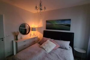 a bedroom with a bed with a mirror and a dresser at Spectacular apartment, all new with fantastic view in Reykjavík