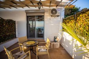 a patio with a table and chairs and a window at Apartments Bogojevic in Ulcinj