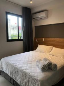a bedroom with a bed with towels on it at Shades of gray 5 in São Paulo