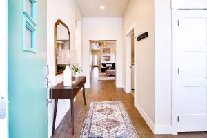 a hallway with a table and a mirror at Guest Favorite 3BD 2BA Meridian Home for Business & Pleasure in Meridian +42 photos