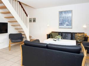 a living room with a couch and a staircase at 8 person holiday home in Gjern-By Traum in Gjern