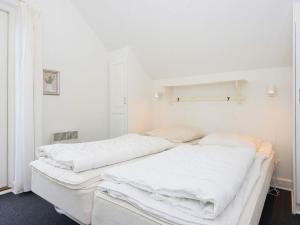 a white bedroom with two beds with white sheets at 8 person holiday home in Gjern-By Traum in Gjern