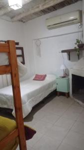 a bedroom with two bunk beds and a fireplace at YANAY in Villa Unión