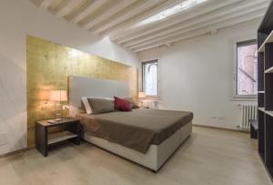a bedroom with a bed and a side table at Cà Del Tentor in Venice