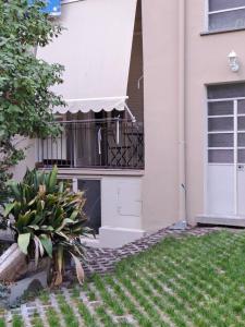 a house with a balcony with a plant in the yard at Marie Antoinette-Pala Alpitour- Private Parking in Turin