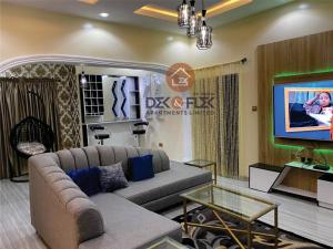 a living room with a couch and a flat screen tv at Dex & Flex Apartments 2 in Ibadan