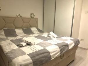 a bedroom with a bed with two pillows on it at Colors Apartment Sarajevo in Sarajevo