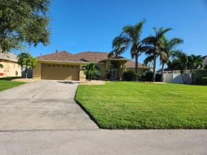 a house with palm trees and a driveway at Casa in The Cove in Cape Coral