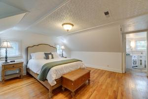 a bedroom with a bed and a wooden floor at Cozy Grants Pass Home about 9 Mi to Rogue River Access in Grants Pass