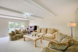 a living room with two couches and a coffee table at Stunning Home on Golf Course about 8 Mi to Disneyland! in Buena Park