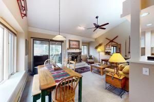 a dining room and living room with a table and chairs at Moose Creek Lodge in Wilson