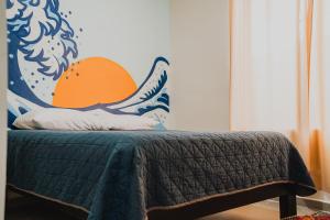 a bedroom with a bed with a dinosaur on the wall at a 5 min de la playa alberca privada by G P S rentas in Mazatlán
