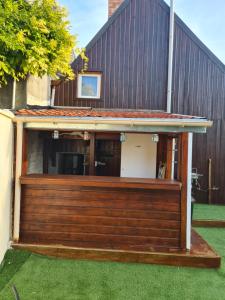 a house with a deck with grass at LA REUNION LE LA 