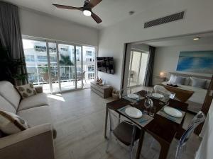 a living room with a couch and a table at Beach Haven 1BDR Condo Paseo Playa Coral - 305 in Punta Cana