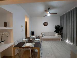a living room with a table and a couch at Beach Haven 1BDR Condo Paseo Playa Coral - 305 in Punta Cana